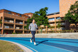 © leungchopan - Young woman jogging on outdoor running track