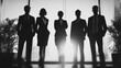 © Broccolini - A powerful black and white silhouette of a diverse business team standing together in a modern high-rise office against a bright window, symbolizing leadership and corporate success.