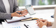 © Fahng - Smiling asian businesswomen financial advisor explaining financial result showing calculator to client or Collegue  in meeting.