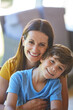 © peopleimages.com - Smile, hug and portrait of mother with son in home for bonding, support and connection. Love, happiness and relax with people in living room of apartment for care, commitment and trust together