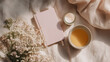 © Creative Fox - Flat lay of pastel pink notebook and morning tea with spring flowers, copy space for daily quote