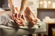 © Studio Romantic - Massage therapist relaxes client feet at spa. Hands apply oil on foot soles in a spa, ideal for reflexology treatment and relaxation. Calm restorative care concept for wellness branding.