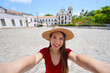 © zigres - Young tourist woman takes selfie with Sao Bento convent in the historic center of Olinda, Pernambuco, Brazil