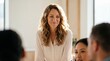© ryker - Smiling woman with wavy hair female leader business meeting medium closeup natural light confident expression professional attire office interior teamwork diverse colleagues