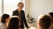 © ryker - Professional female executive leading small meeting with confident expression in sunlit modern office