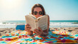 © Sonya - Woman reading a book on colorful beach towel with ocean view