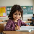 © Hasanul - A young girl sitting at a desk in a classroom with an open notebook and a pencil, smiling.