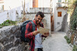 © Novak - Young man with backpack and map exploring a historic old town