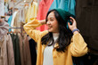 © Parichat - Young Asian woman shopping for fashion beanie