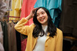 © Parichat - Young Asian woman smiling shopping for clothes