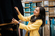© Parichat - Young woman shopping for clothes in retail store