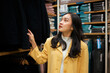 © Parichat - Woman browsing clothing in retail store for shopping