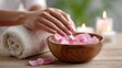 © Jane_S - Female hands with petals in wooden bowl for relaxing spa treatment