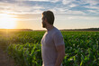 © Volodymyr - A farmer inspects the cornfield on sunset. The male farmer works outdoors in the field. Agricultural worker farmer harvesting corn. A man examines the maize crop. The farmer cultivates corn on farm.