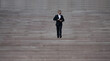 © Volodymyr - Businessman walking up stairs as a symbol of career growth and success. Business step. Future goal and victory. Business man on stairs. Man climbing on stairs. Man in a suit moving up stairs.