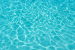 © Glorious - Crystal clear turquoise swimming pool water with sunlight caustics Bright turquoise water surface featuring shimmering white light reflections and gentle ripples