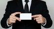 © RUMA - Man in black suit holding blank white card with both hands white shirt black tie blank card