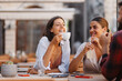 © Novak - Two women and a man enjoying a coffee break on a cafe terrace, laughing and having a casual conversation