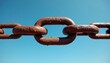 © Vadym - Rusty metal chain links hang against a clear blue sky, showing texture and age. The strong connection symbolizes durability and security, representing endurance through time.