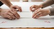 © Ilham - Close-up of a couple's hands meticulously folding a white embroidered tablecloth, demonstrating teamwork and attention to detail in home preparation for a special occasion