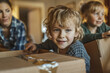 © PhotoProAD - A boy is sitting in a cardboard box