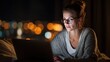 © acilll - Woman using laptop computer at night bokeh background working from home
