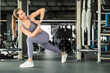 © ty - Young sporty woman stretching at the gym
