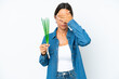 © luismolinero - Young hispanic woman holding chive isolated on white background covering eyes by hands. Do not want to see something