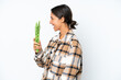 © luismolinero - Young hispanic woman holding a green beans isolated on white background laughing in lateral position