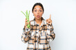 © luismolinero - Young hispanic woman holding a green beans isolated on white background intending to realizes the solution while lifting a finger up