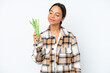 © luismolinero - Young hispanic woman holding a green beans isolated on white background looking to the side and smiling