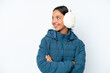 © luismolinero - Young hispanic woman wearing a winter earmuffs isolated on white background happy and smiling