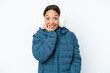 © luismolinero - Young hispanic woman wearing a winter earmuffs isolated on white background with surprise and shocked facial expression