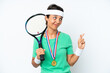 © luismolinero - Young tennis player woman isolated on white background with fingers crossing and wishing the best