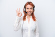 © luismolinero - Telemarketer Russian girl working with a headset isolated on white background showing ok sign with fingers