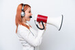 © luismolinero - Telemarketer Russian girl working with a headset isolated on white background shouting through a megaphone
