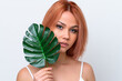 © luismolinero - Young Russian girl isolated on white background holding a palm leaf. Close up portrait