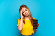 © luismolinero - Teenager girl holding chocolat over isolated blue background with headache