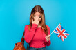 © luismolinero - Young girl holding an United Kingdom flag over isolated blue background with tired and sick expression