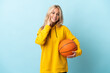 © luismolinero - Young Russian woman playing basketball isolated on blue background smiling with a happy and pleasant expression