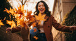 © Guillotine - Young Asian woman smiling and playing with autumn leaves outdoors