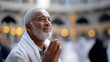 © Дмитрий Лазебный - Faceless elderly Muslim man in traditional attire standing solemnly before Kaaba, reverence and devotion captured, spiritual significance moment, crowd of pilgrims defocused background, with copy