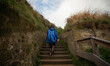 © My Ocean studio - Woman walking up outdoor stairs on a hiking trail