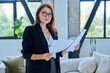 © Valerii Honcharuk - Portrait of middle-aged confident businesswoman with business papers