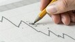 © adaptable_ Lark98A1 - A hand holding a pencil draws a fluctuating line on a graph, symbolizing analysis or financial trends.