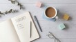 © PrismPNG - Overhead flat lay view of a February monthly planner open beside coffee and eyeglasses
