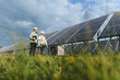 © Serhii - Engineers inspecting large solar power panels in field
