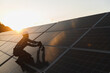 © Serhii - Worker installing solar panels practicing sustainable energy