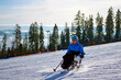 © Alex - A man in a blue jacket confidently skis