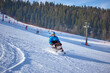 © Alex - Active recreation in the mountains - a man in a blue jacket confidently skis down a mountain